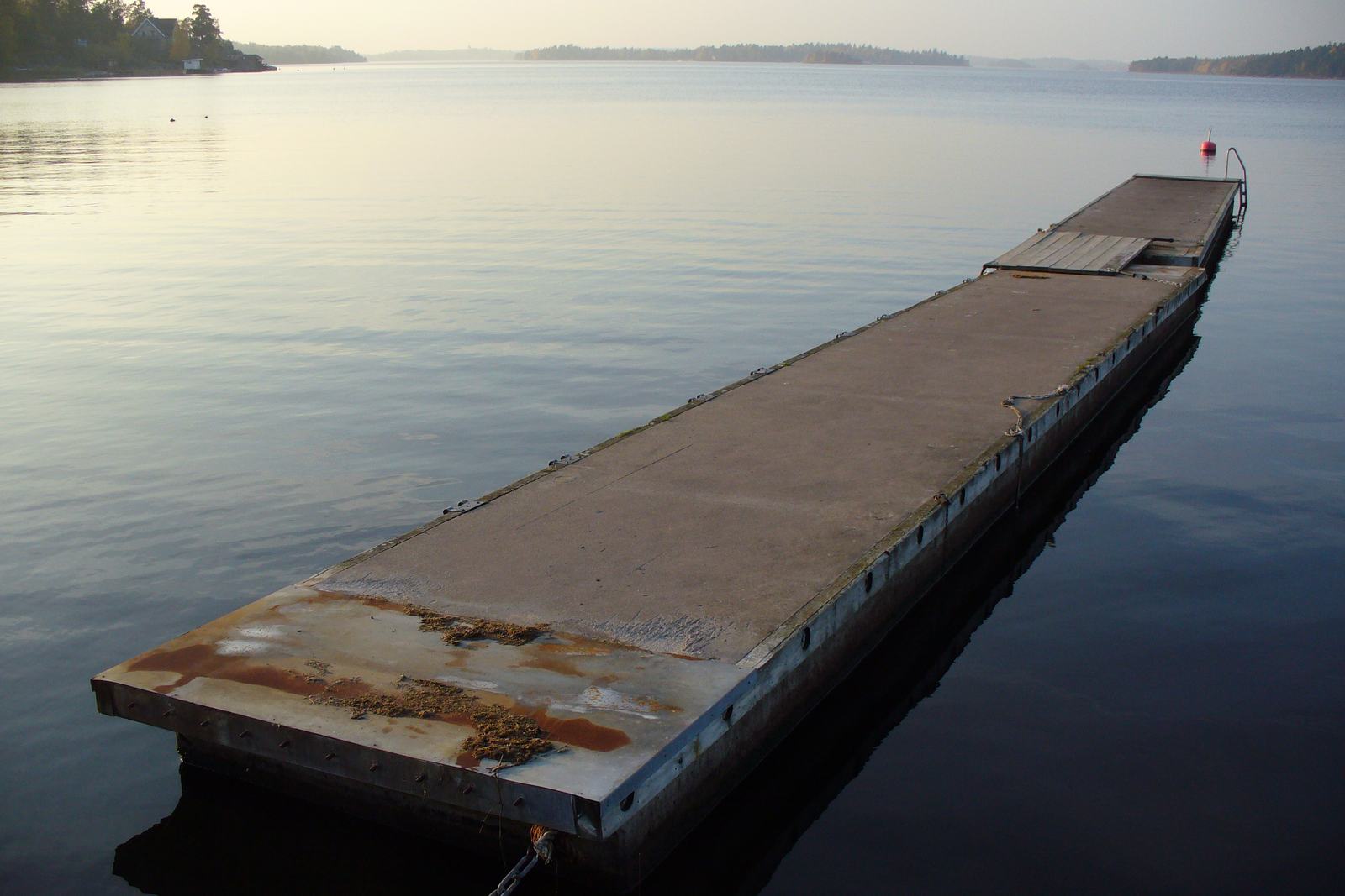 Flat steel barge platform floating alongside