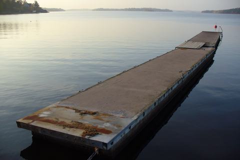 Flat steel barge platform floating alongside
