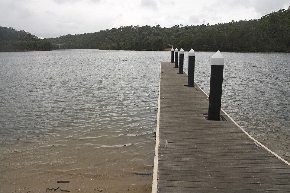Timber jetty decking running out over an Australian waterway