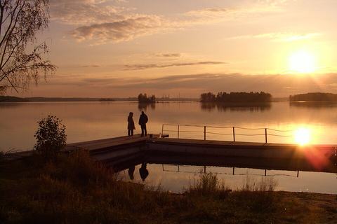 Small floating dock on still water at sunset