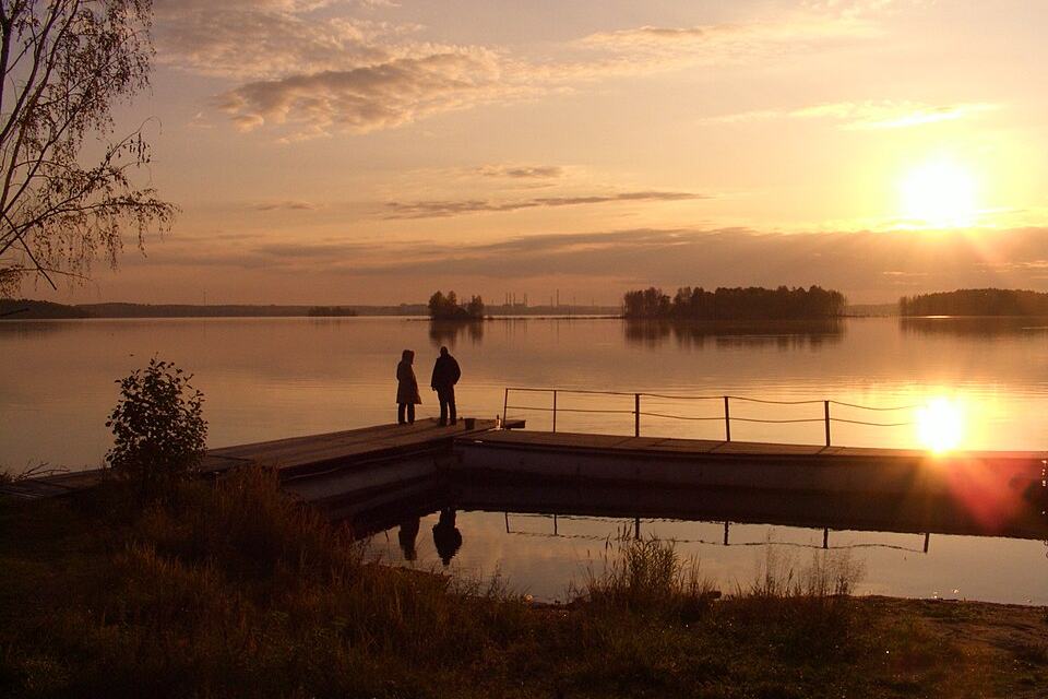 Small floating dock on still water at sunset