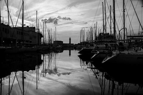 Masts and berths in a quiet marina basin