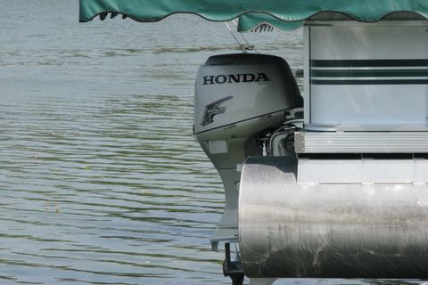 Outboard engine mounted on a pontoon boat transom